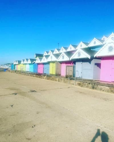 a row of colorful buildings on a street at Modern 3 bedroom caravan near the beach in Walton-on-the-Naze