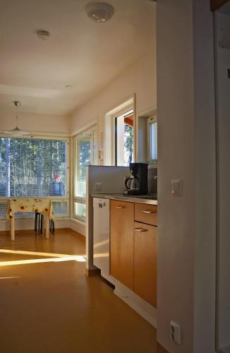 an empty kitchen with a table and a window at Rastila Camping Helsinki in Helsinki