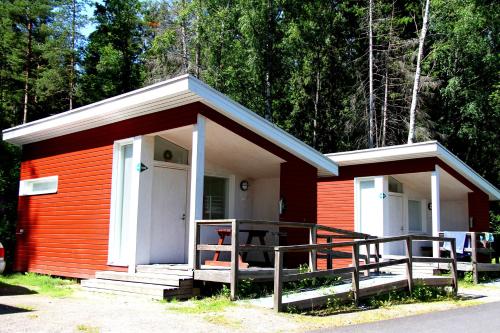 a small red and white building with a porch at Rastila Camping Helsinki in Helsinki
