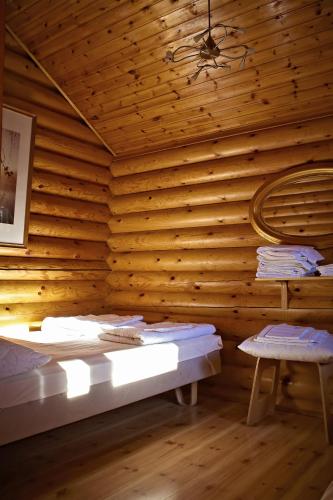 a room with a wooden wall with a bed and a chair at Rastila Camping Helsinki in Helsinki