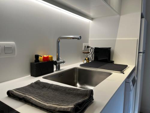 uma cozinha com um lavatório e uma torneira em Apartaments ApturVic en el Centre Històric em Vic