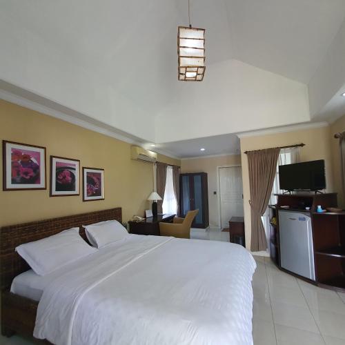 Ένα ή περισσότερα κρεβάτια σε δωμάτιο στο Tengger Guesthouse