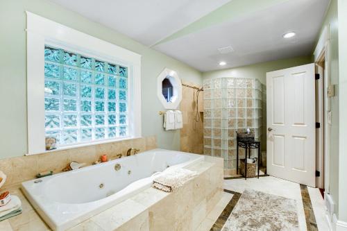 a large bathroom with a tub and a window at The Lighthouse in La Conner