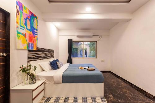 a bedroom with a bed and a window at StayVista's Vine & Splash - Riverside villa with an infinity pool and indoor games in Karjat