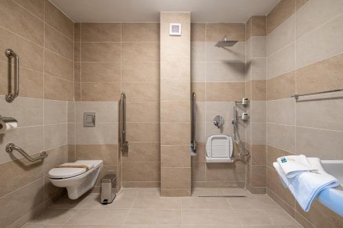 a bathroom with a toilet and a shower at Fiald Hotel & Spa in Bacău