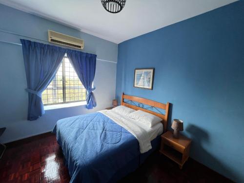 une chambre bleue avec un lit et une fenêtre dans l'établissement 2 Bedroom Apartment @ Bay View Port Dickson, à Port Dickson