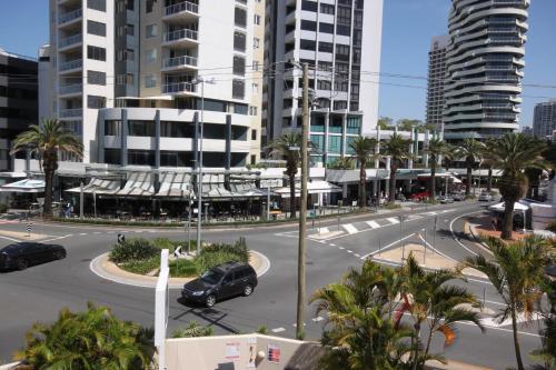 a car driving down a street in a city at Aruba Beach Resort in Gold Coast