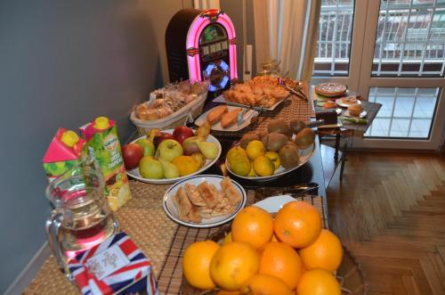 a buffet of food with oranges and other foods at Sweet Home Parioli in Rome