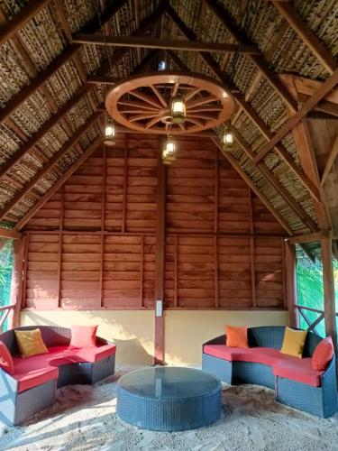 a room with red and blue couches and a ceiling at The Tottam Beach Hotel - Trincomalee in Trincomalee