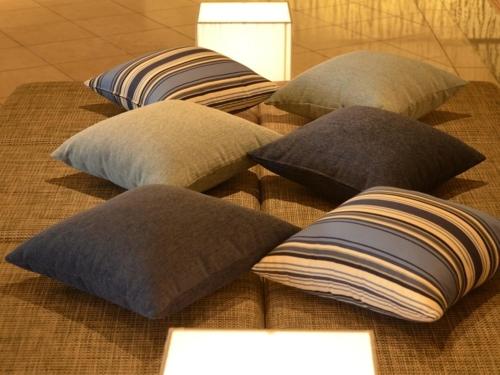 a group of pillows sitting on top of a bed at Atami Seaside Spa & Resort in Atami