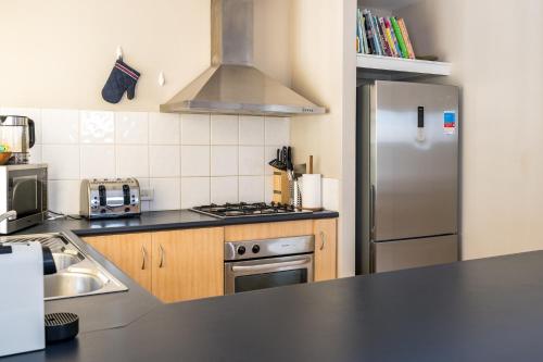 a kitchen with a stainless steel refrigerator and a stove at Lime Tree Haven in Margaret River Town