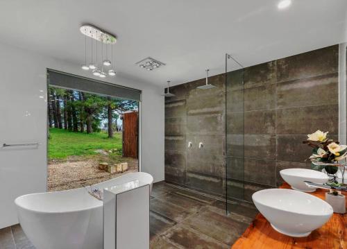 a bathroom with two sinks and a glass wall at Bella Cosa in McLaren Vale