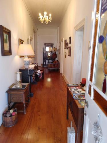a living room with wooden floors and a chandelier at Yellowwood Lodge in Knysna