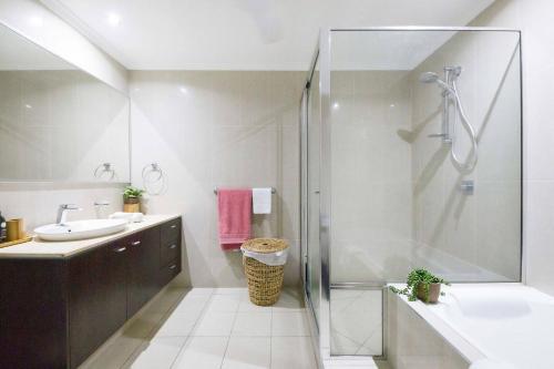 a bathroom with a shower and a sink at 'Pearl Paradise' A Tropical Oasis with Ocean Views in Darwin