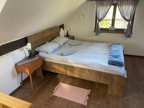 a bedroom with a large bed with a wooden headboard at Holiday home DEDINA HIŽICA in Sveti Urban