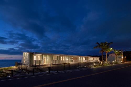 a building on the side of the road at night at ALFACIO RESORT STAY ITOSHIMA in Itoshima
