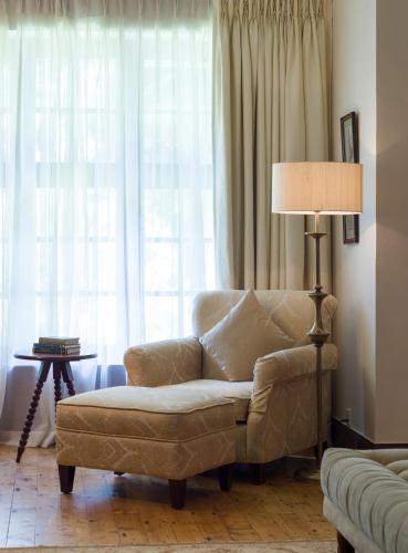 a living room with a couch and a lamp at Ceylon Tea Trails - Relais and Chateaux - All Inclusive in Hatton