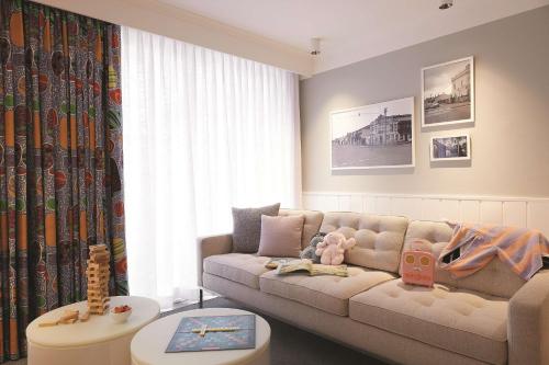 a living room with a couch and a table at Adina Apartment Hotel Chippendale in Sydney