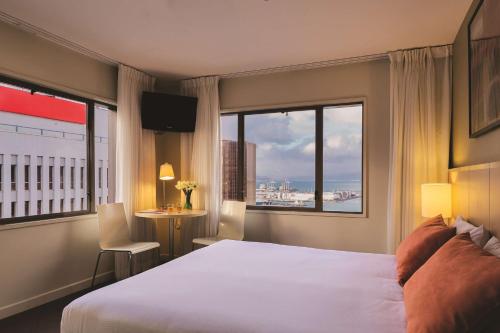 a hotel room with a large bed and a window at Travelodge Hotel Wellington in Wellington