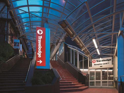 a building with stairs and a sign in front of it at Travelodge Hotel Wellington in Wellington