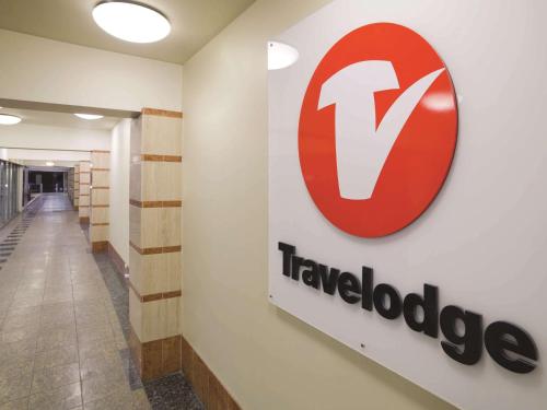 a sign on a wall in a hallway with a travelodge sign on it at Travelodge Hotel Wellington in Wellington