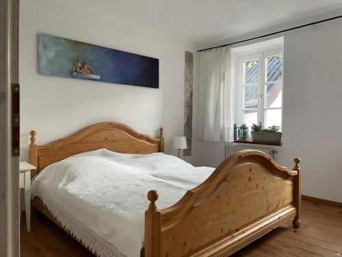 a bedroom with a wooden bed and a window at Gartenhaus - a68978 
