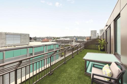 a balcony with a table and chairs on a building at Adina Apartment Hotel Auckland Britomart in Auckland
