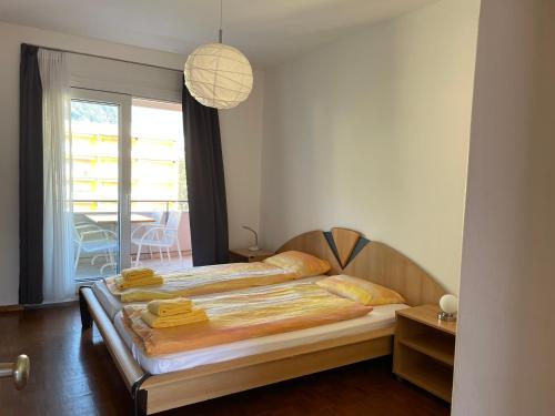 a bedroom with a bed with towels on it at Locarno: Casa Lido in Locarno