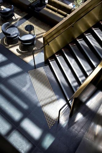 a group of stairs and chairs in a building at A by Adina Sydney in Sydney