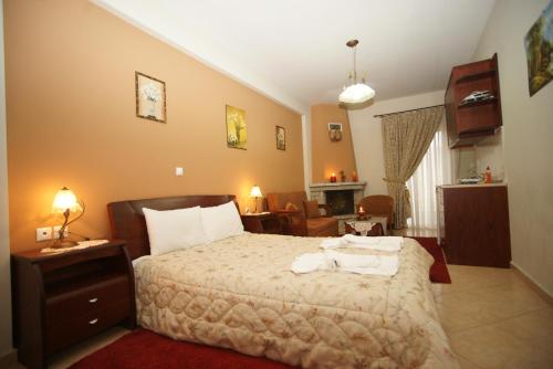 a bedroom with a bed and a living room at Hotel Orama in Kryonérion