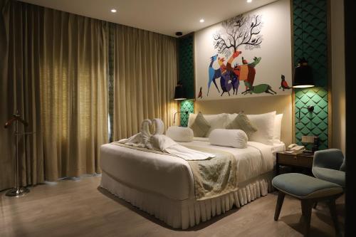 a bedroom with a bed and a painting on the wall at THE CRUZE PREMIUM BOUTIQUE HOTEL in Jamshedpur