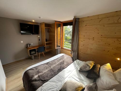 a bedroom with a bed with a wooden wall at 9WAGRAM Hotel Boutique in Le Mans