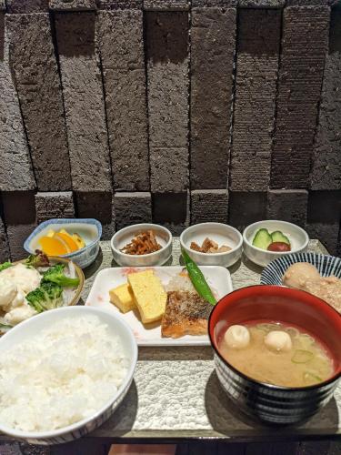 a table with a plate of food and bowls of food at Tmark City Hotel Kanazawa in Kanazawa