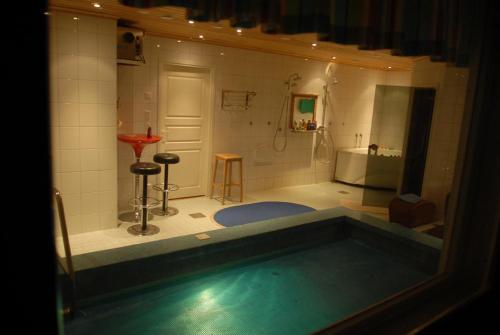 a bathroom with a bath tub and a shower at Villa Harald - Beachfront in Hitis