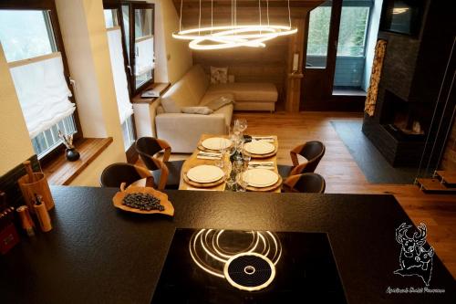 a dining table and chairs in a living room at Apartment-Chalet Panorama in Todtmoos