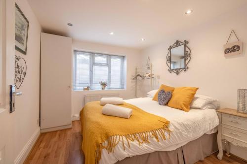 Windsor centre Parkview في ويندسور: غرفة نوم عليها سرير مع بطانية صفراء