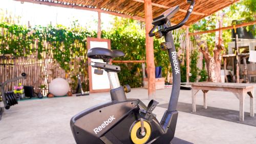 a electric scooter parked in a patio with a bench at The Mida Creek Hotel in Watamu