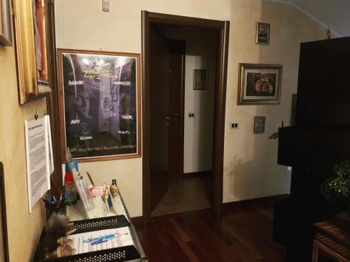 a room with a hallway with a door and a desk at B&BMagicHouse in Novara