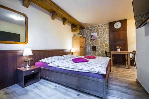 a bedroom with a large bed and a mirror at Apartmány Slunce in Harrachov