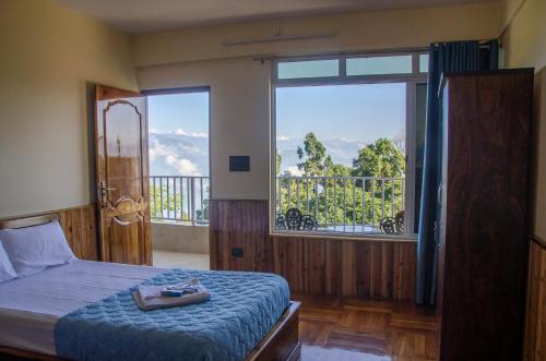 a bedroom with a bed and a large window at The Brick House Stay in Kalimpong