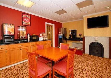 a dining room with a table and chairs and a fireplace at Inn at Monticello in Monticello