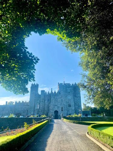 a castle in the middle of a road at Kilkea Castle in Kilkea