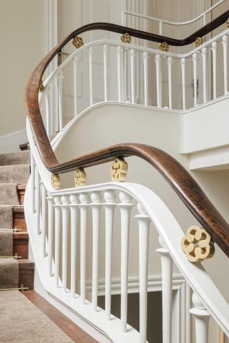 a white spiral staircase with wooden railings at Casa Kala in Porto