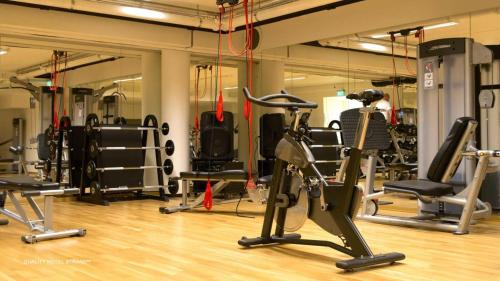 a gym with a bunch of exercise equipment in it at Quality Hotel Strand Gjøvik in Gjøvik