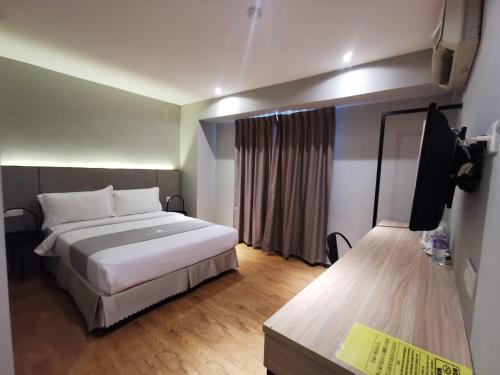 a hotel room with two beds and a window at OCEAN HOTEL in Labuan