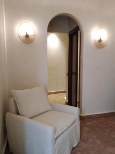 a living room with a white couch and a mirror at Riad Lalla Mimouna in Marrakech