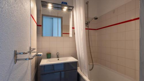 a bathroom with a sink and a mirror and a tub at Grand Morillon - 104 - Montagne Belle Vue Studio 4 in Morillon