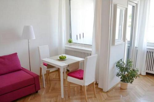 a living room with a table and a red couch at Apartment Castle View in Budapest