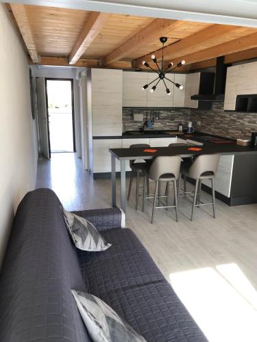 a kitchen and living room with a couch and a table at Marinella House in Sarzana