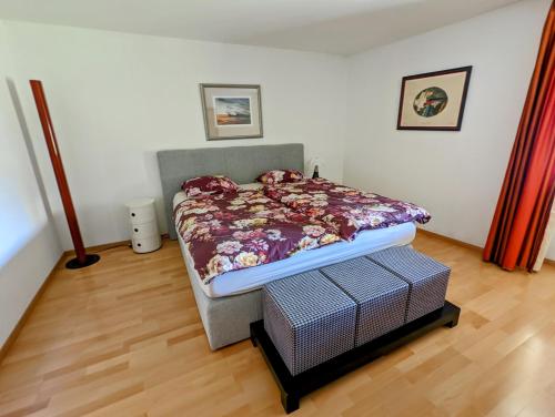 a bedroom with a bed and a wooden floor at Domaine de la Crausaz in Grandvaux
